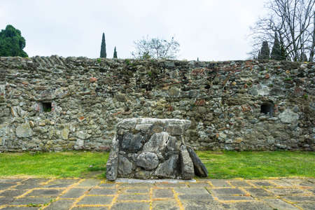 Ancient dolmen on stone wall background in history reserve Pitsunda, Abkhazia.