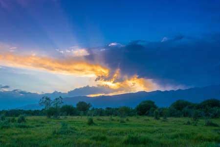 Bright beautiful summer sunset in the foothills of the Tien Shan, Kyrgyzstan.の写真素材