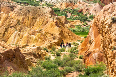 Cheerful young people dancing in a beautiful canyon Fairy tale, Kyrgyzstan.