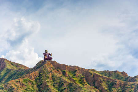 Monument manaschy Sayakbai Karalaev, storyteller and narrator epics is set high on a mountain, Kyrgyzstan.の写真素材