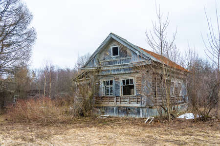 Abandoned old wooden house in the spring cloudy day.の写真素材
