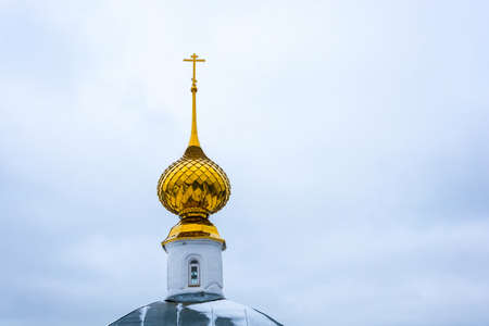 Beautiful Golden Church dome in the background of the cloudy sky.の写真素材