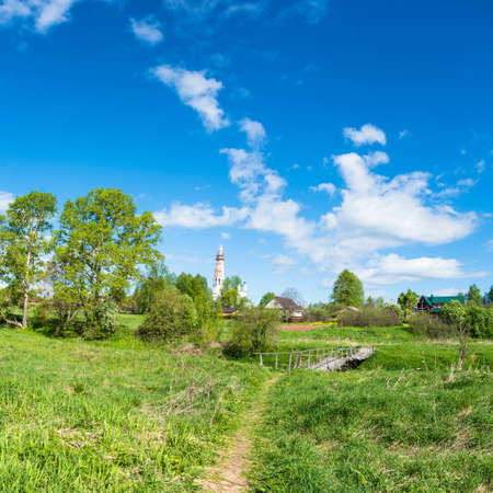 View of the village of Mikhailovskoye with views of the Church of the Holy Archangel Michael and the bodiless hosts on a Sunny spring day.の写真素材