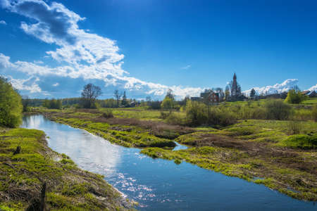 View of the village of Mikhailovskoye with views of the Church of the Holy Archangel Michael and the bodiless hosts on a Sunny spring day.の写真素材