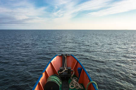 The nose of a small ship and the boundless calm of the White sea in an evening summer day. の写真素材