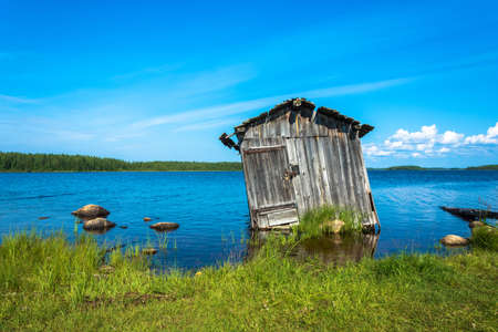 A rickety old shed on the shore of a small lake in Karelia, Russia.の写真素材