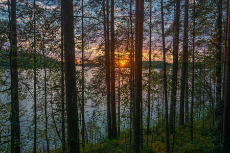 Beautiful purple sunset on a small lake in Karelia, Russia.の写真素材