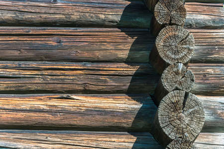 Texture of the walls of the old log house in bright sunlight.の写真素材