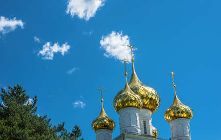 Bright gold Church domes against the blue sky.の写真素材