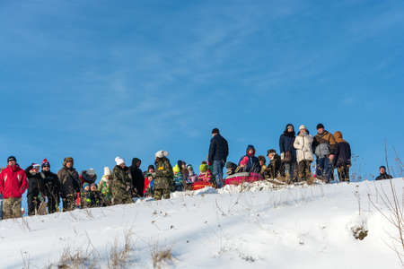 Uglich city, Yaroslavl region, Russia - 10/02/2018: Spectators at the festival Winter fun in Uglich, 10.02.2018 in Uglich, Yaroslavl region, Russia.のeditorial素材