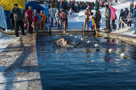 Uglich city, Yaroslavl region, Russia - 10.02.2018: Competitions in swimming in icy water, at the festival Winter fun in Uglich, 10.02.2018 in Uglich, Yaroslavl region, Russia.のeditorial素材
