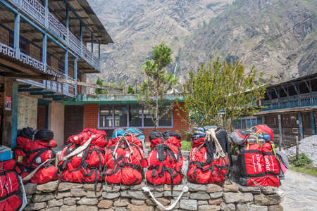 Tal, Nepal-March 29, 2018: Large red backpacks in the village of Annapurna March 29, 2018 in Nepal.