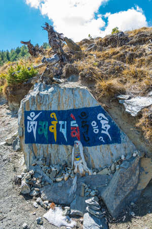 Colored inscriptions on stones in the mountains of Nepal on a Sunny day.の写真素材
