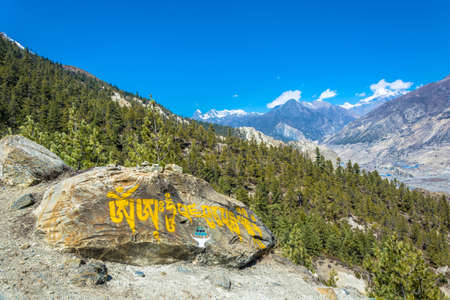 Colored inscriptions on stones in the mountains of Nepal on a Sunny day.の写真素材