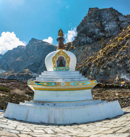 Beautiful white stone stupa against mountains and blue sky in Himalayas, Nepal.の写真素材