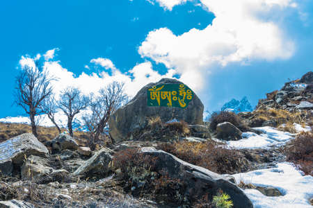 Colored inscriptions on stones in the mountains of Nepal on a Sunny day.の写真素材