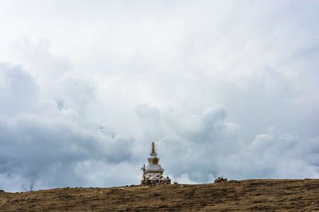 The great stone Buddhist stupa against the background of the cloudy sky in Himalayas, Nepal.の写真素材