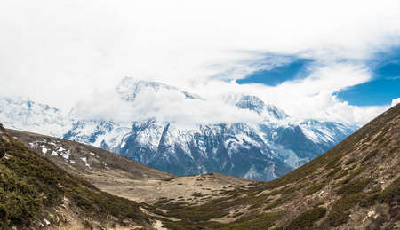 Beautiful mountain landscape with snowy mountains and clouds in the Himalayas, Nepal.の写真素材