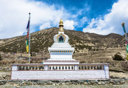 Large white stone Buddhist stupa in a mountain village in the Himalayas, Nepal.の写真素材