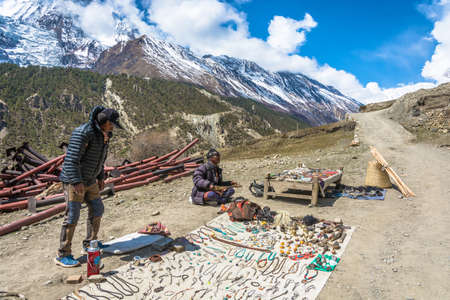 Manang village in the Himalayas, Nepal-05.04.2018: two Nepalese are selling local Souvenirs on April 5, 2018 in the mountain village of Manang in the Himalayas , Nepal.のeditorial素材
