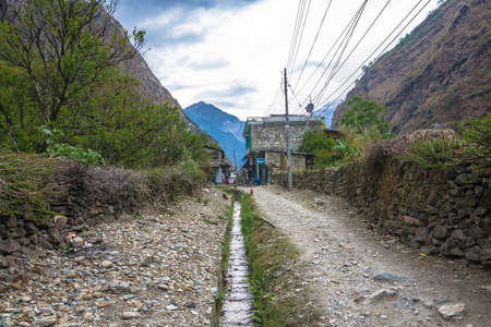 Tatopani, Nepal-09.04.2018: Narrow village street in mountain village 9 April 2018 Tatopani, Nepal.のeditorial素材