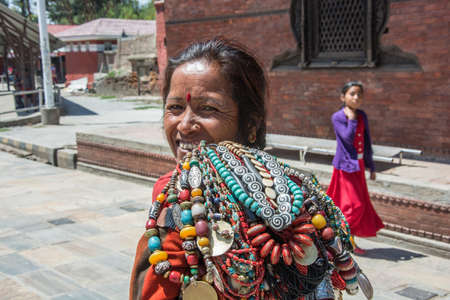 Kathmandu, Nepal-04/14/2018: an Elderly woman sells jewelery on April 13, 2018 to Kathmandu, Nepal.のeditorial素材