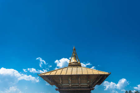 Original decoration on top of Buddhist temple on blue sky background, Nepal.の写真素材