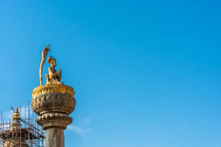 Original decoration on top of Buddhist temple on blue sky background, Nepal.の写真素材