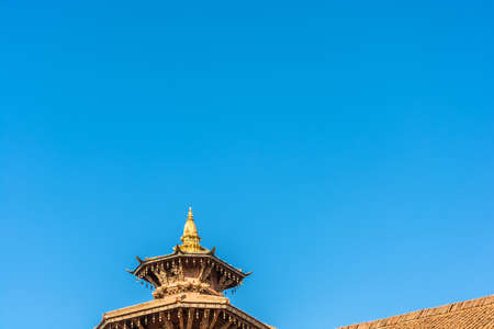 Original decoration on top of Buddhist temple on blue sky background, Nepal.の写真素材