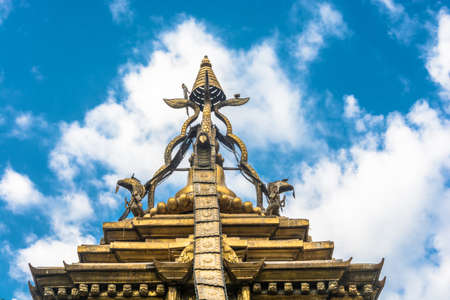 Original decoration on top of Buddhist temple on blue sky background, Nepal.のeditorial素材