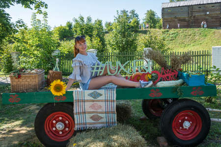 Luh, Ivanovo Region, Russia - 08/25/2018: Beautiful girl is photographed for memory at the regional festival-fair Luk-luchok August 25, 2018 in the city of Luh, Ivanovo region, Russia.のeditorial素材