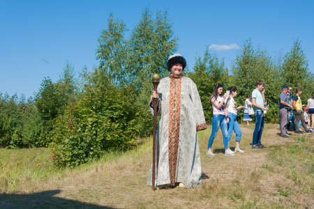 Luh, Ivanovo region, Russia - 08/25/2018: Woman in Russian clothes and with a staff at the regional festival-fair Luk-luchok August 25, 2018 in the city of Luh, Ivanovo region, Russia.のeditorial素材