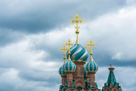 Beautiful church domes with gold crosses against a cloudy sky on a cloudy day.の写真素材