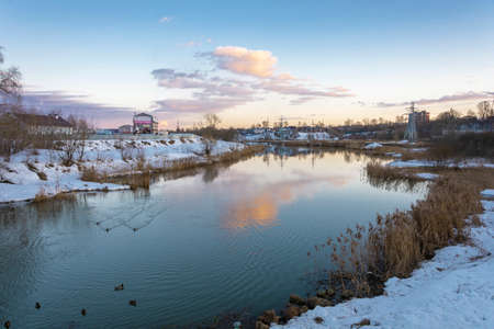 Beautiful spring landscape with a small quiet river in the evening.