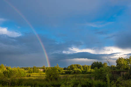 A multicolor rainbow against a summer day, Russia.の写真素材