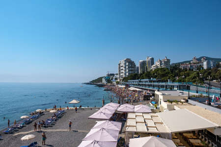 Yalta, Crimea - 09/03/2019: Beach on the Black Sea coast on a summer sunny day.のeditorial素材