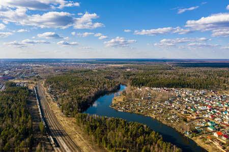 A panorama of the village of Gorino and the Kharinka River from a bird's flight on a spring sunny...
