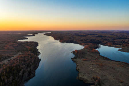 Red-orange sunset on the Uvodsky reservoir, Ivanovo Region, Russia, photo taken from a drone.