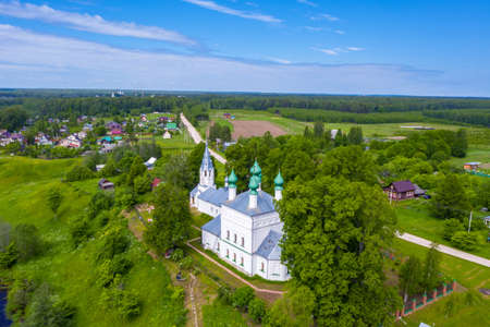 A snow-white church with green domes in the village of Krasnoarmeyskoye, Ivanovo Region on a summer day, photo taken from a drone.の写真素材