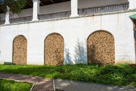 A pile of dry birch firewood in the wall of the Spaso-Yakovlevsky Monastery in the city of Rostov, Yaroslavl region, Russia.の写真素材