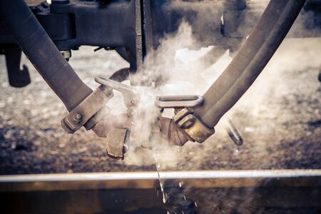 Very hot steam comes out of a pipe from an old steam railwayの写真素材