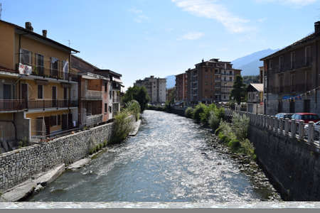 The Dora River in Susa in the province of Turin runs through the housesの写真素材