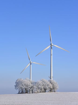 Wind turbines and trees in winter, Germanyの写真素材