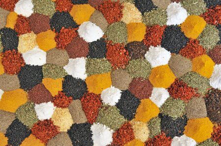 close-up of mixed herbs and spices in a patchwork display at a marketの写真素材