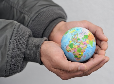 Globe in asian man's handsの写真素材