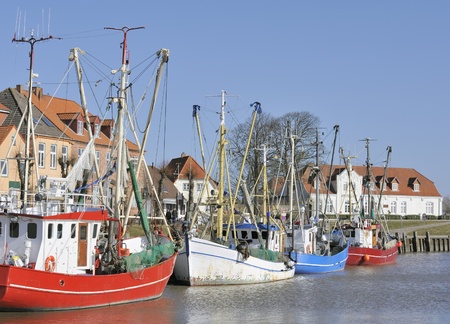 Colored fishing boats in harbor, Tonner, Germanyの写真素材