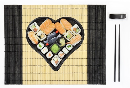 Heart shaped sushi and sashimi plate on tableの写真素材