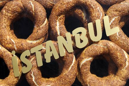 Simit or Turkish bagel and istanbul sign in frontの写真素材