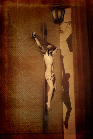Sculpture of Jesus on the cross, with shadow on the wall  Grunge style  Real old film grain の写真素材