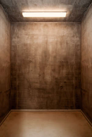 Empty grunge industial room background illuminated with lamp.の写真素材